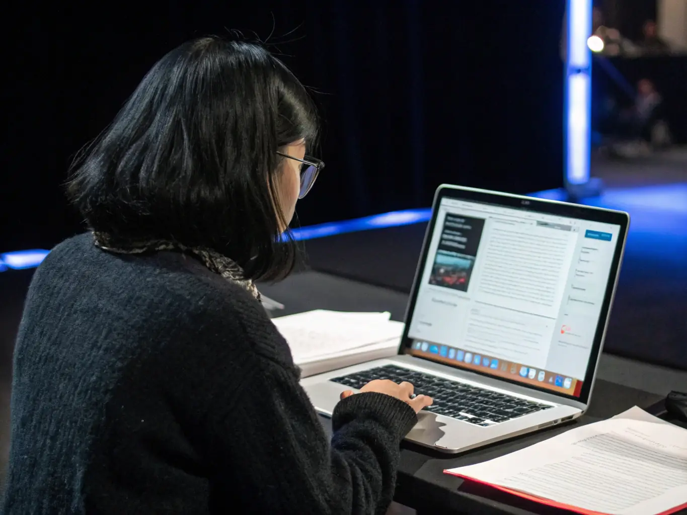 An image of a professional editing a PDF document on a laptop, with AI-powered data extraction highlights.